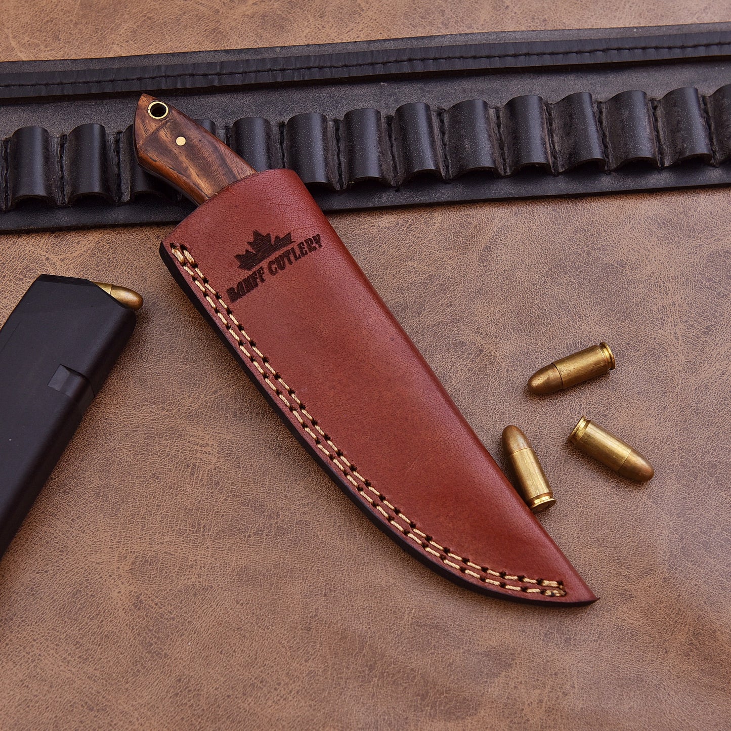The Ridge Breaker Knife shown with its genuine leather sheath, offering safe storage and easy portability.