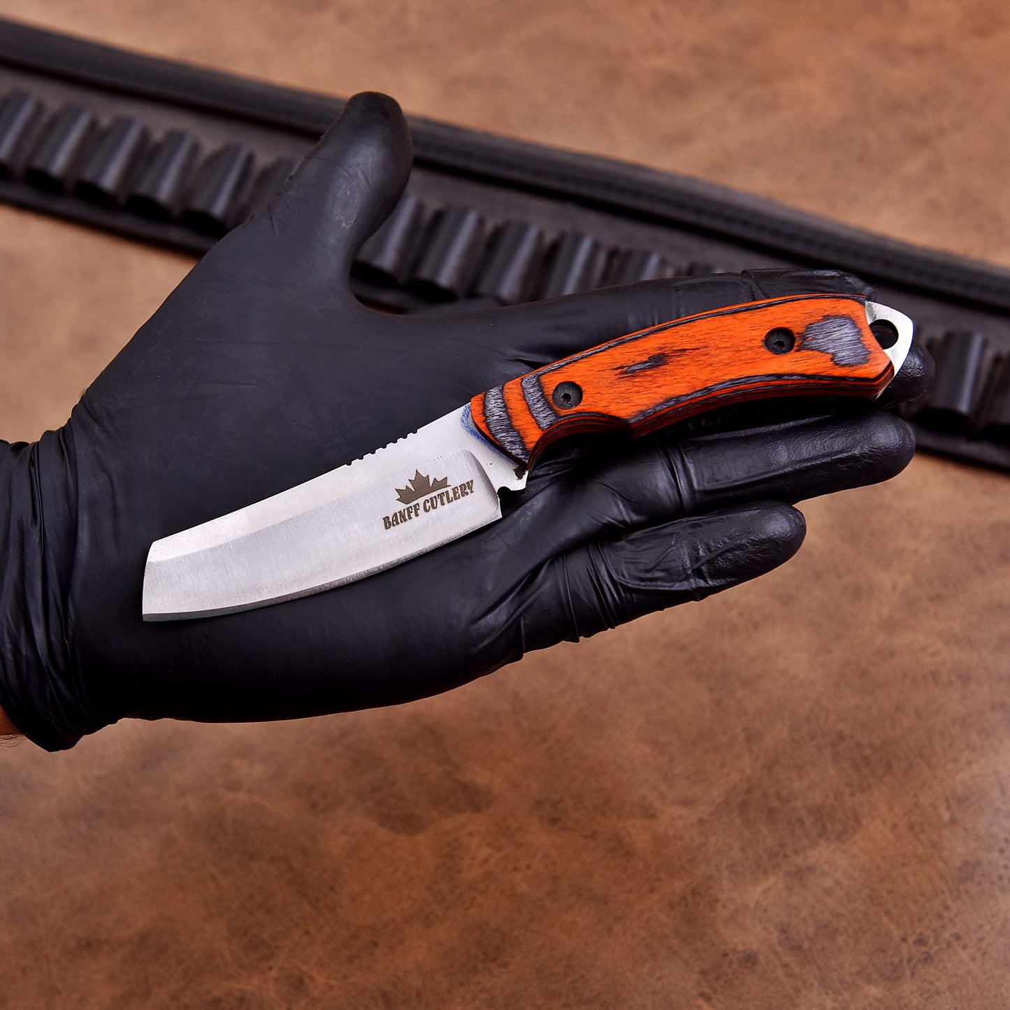 Durable full tang hunting and bushcraft knife with custom leather sheath for outdoor enthusiasts.