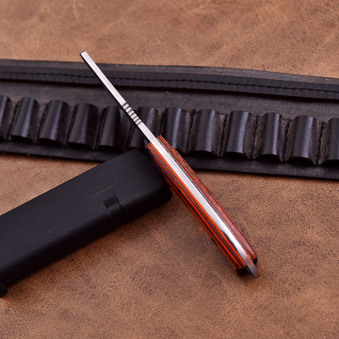 High-performance skinning knife with sharp stainless steel blade and exotic polished wood grip.