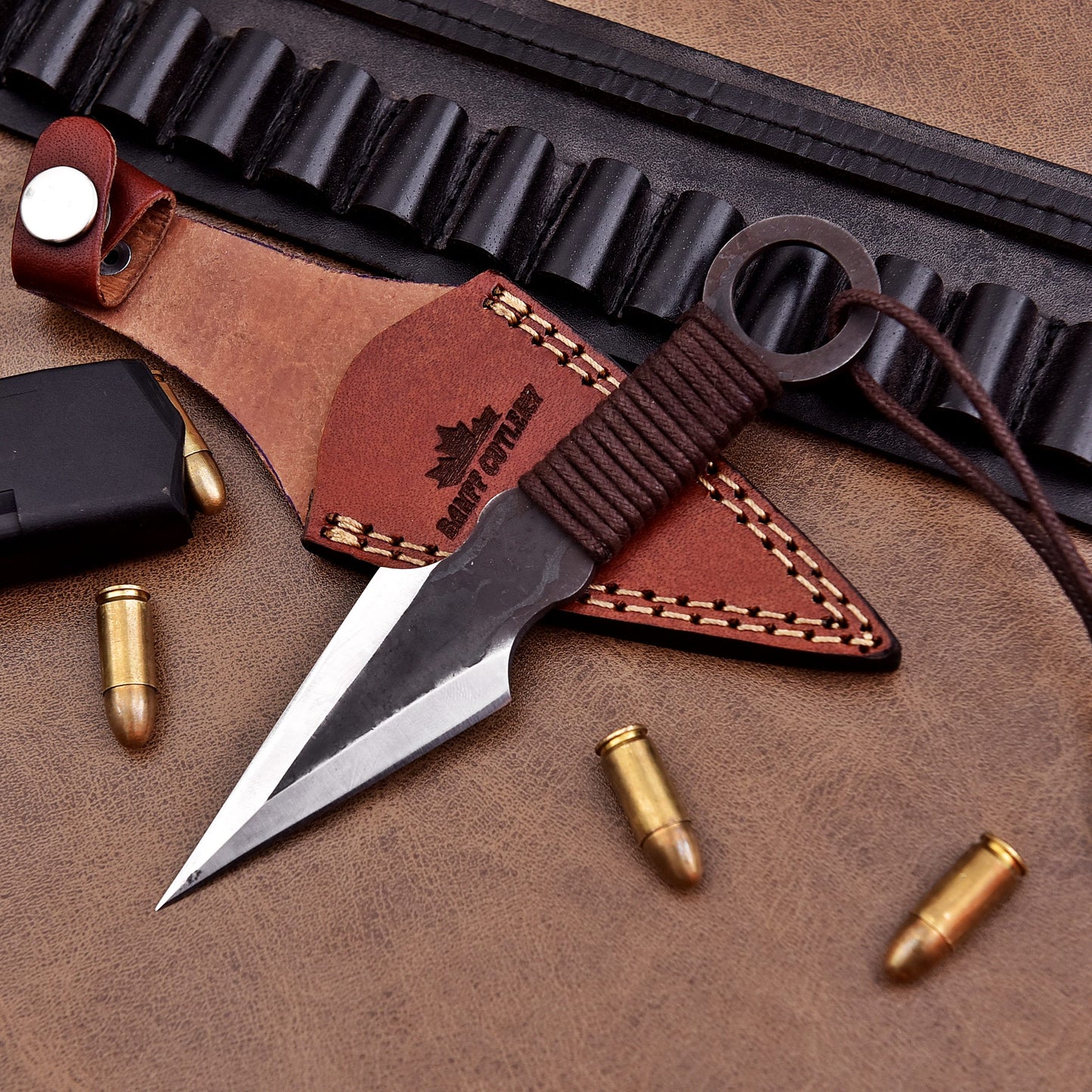 Professional D2 steel throwing knife with full tang design and leather sheath for target practice.