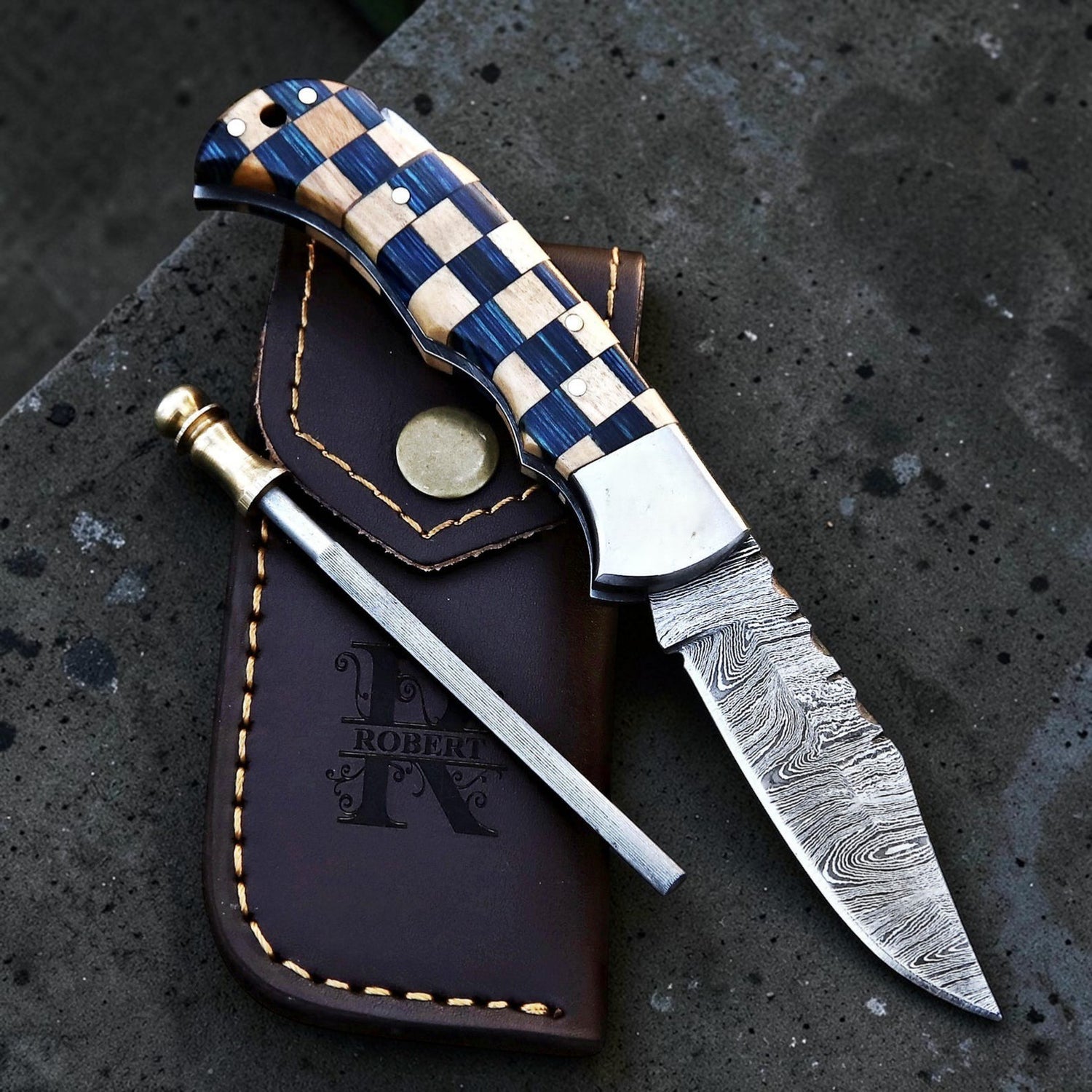 A razor sharp damascus steel folding with fire starter and leather sheath.