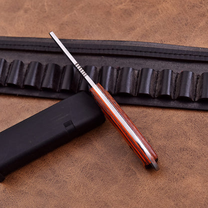 High-performance skinning knife with sharp stainless steel blade and exotic polished wood grip.